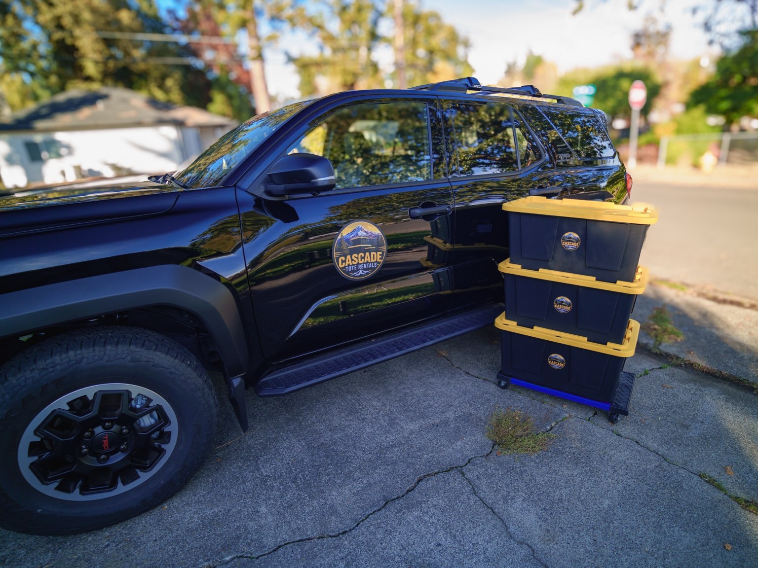 Cascade reusable moving totes and dollies ready beside the delivery vehicle