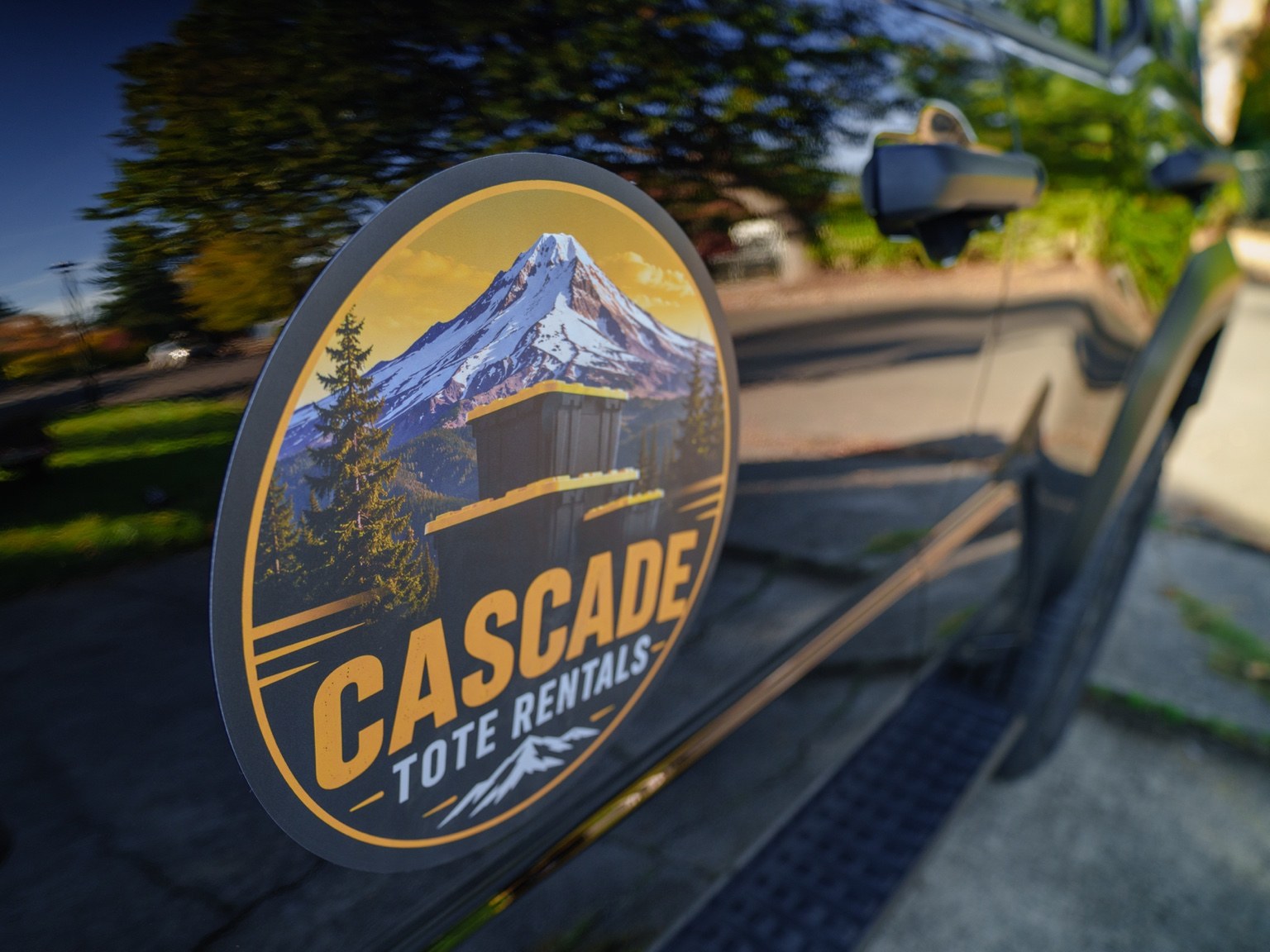 Close-up of the Cascade Tote Rentals mountain logo on a moving tote